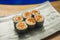 Delicious and delicate dish of Japanese sushi rolls on beautiful slate set up in traditional healthy Asian food and creative