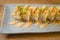 Delicious and delicate dish of Japanese sushi rolls on beautiful slate set up in traditional healthy Asian food and creative