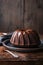 Delicious dessert, dark chocolate bundt cake topped with ganache glaze with copy space