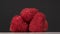 Delicious dessert of raspberries rotates on a gray background. Close up