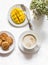 Delicious dessert, snack on a light background - cappuccino, fresh ripe mango, cookies, top view