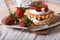 Delicious dessert: waffles with fresh strawberries and cream