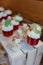 Delicious desserts, berry mousses decorated with whipped cream and berries in glass cups .