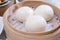 Delicious dim sum, famous cantonese food in asia, fresh and hot salted creamy custard buns in bamboo steamer in hong kong yumcha