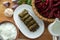 Delicious dolma sarma rice, white yogurt sauce . Garlic, red onion, tarragon . In a stuffed white plate . Yogurt and dried beans