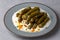 Delicious dolma (sarma) stuffed grape leaves rice, white yogurt sauce.