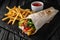 A delicious doner donair kebab wrap with meat, lettuce, tomato, red onion and sauce with french fries