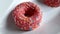 Delicious donut on white background with pink chocolate frosted icing and sweet donuts sprinkled with sweets
