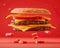 Delicious Double Cheeseburger with Melting Cheese and Sesame Bun on Vibrant Red Background