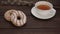 Delicious doughnuts and hot tea. donut topped with icing sugar and a bright sprinkle.