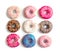 Delicious doughnuts with sprinkles on light background