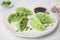 Delicious dumplings (gyozas) and soy sauce on white tiled table, closeup