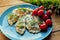 Delicious dumplings with parsley on a blue plate.