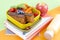 Delicious Dutch breakfast with sweet bread and berries. Food for children in school. School accessories and exercise books. Top