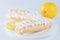 Delicious eclair on a plate and lemon