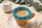 Delicious edible biscuit cup of espresso decorated with sprinkles on table, closeup