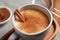 Delicious eggnog with anise and cinnamon on wooden table, closeup