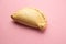 Delicious empanada isolated on pink background