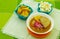 Delicious encebollado fish stew from Ecuador traditional food national dish closeup, with pocorn and some chifles of