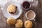 Delicious English scones with jam and tea close-up. Horizontal t