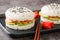 Delicious and exquisite sushi burger with vegetables and salmon fish as Japanese appetizers. Horizontal