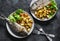 Delicious family lunch table - dorado fish baked with potatoes, lemon and sage on dark background, top view