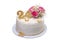 A delicious, festive creamy birthday cake with flowers.