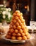Delicious festive croquembouche with caramel glaze on the background of a festive beautiful table.