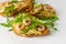 Delicious fitness food. Toasts with avocado, shrimps and arugula on white background.