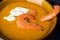 Delicious flavored pumpkin soup with shrimps. Close-up. The aroma of autumn