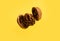 Delicious flying walnut on yellow background.