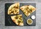 Delicious focaccia bread with green olives on grey table, flat lay