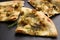 Delicious focaccia bread with green olives on slate board, closeup