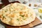 Delicious focaccia bread on wooden board, closeup