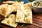 Delicious focaccia bread on wooden board, closeup