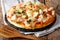 Delicious food: buffalo pizza with chicken breast, tomato concasse and mozzarella cheese close-up. horizontal
