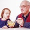 Delicious food. Grandpa feeding his grandchild with fruits salad