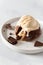Delicious french fondant with hot chocolate centre and ice cream scoop on the plate. Lava cake recipe, menu. Close up