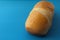 Delicious French roll bread. Soft and sweet bun over blue background.