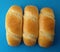 Delicious French roll breads. Soft and sweet buns over blue background.