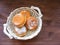 Delicious fresh Berliner in bread basket on vintage wooden background flat view