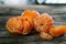 Delicious and fresh clementines, unpeeled and peeled