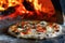 Delicious fresh Italian pizza lies near the oven, baked in a wood-burning oven