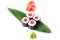 Delicious fresh mini-rolls with tuna on a banana leaf. Sushi rolls on a white background with ginger and wasabi.