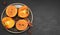 Delicious fresh persimmon fruit on a black background. Persimmon slices on a black plate. Copy space, top view. Ingredients and