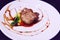 Delicious fresh sliced, pan seared Foie Gras with berry sauce decoration served on white porcelain plate. Duck or Goose Fattened