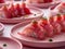 Delicious Fresh Sushi Platter with Sliced Fish, Rice, and Garnish on Elegant Pink Plates for Culinary Delights