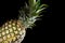 Delicious fresh yellow pineapple tropical fruit on black background
