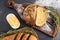 Delicious freshly baked cornmeal bread on a wooden board. homemade butter, a sprig of rosemary. top view. black background