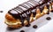 Delicious Freshly Baked Eclair with Smooth Shiny Chocolate Glaze Drizzled Over the Top Isolated on a White Background